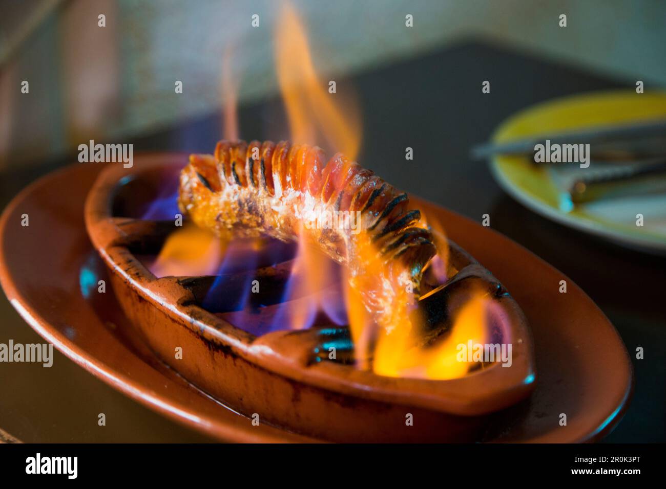 Portuguese sausage is flamegrilled at Restaurante Espaco Lisboa in Coloane Village, Coloane