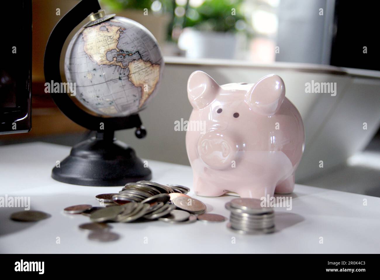 An image of a finance and business concept centered around a piggy bank on an office table Stock Photo