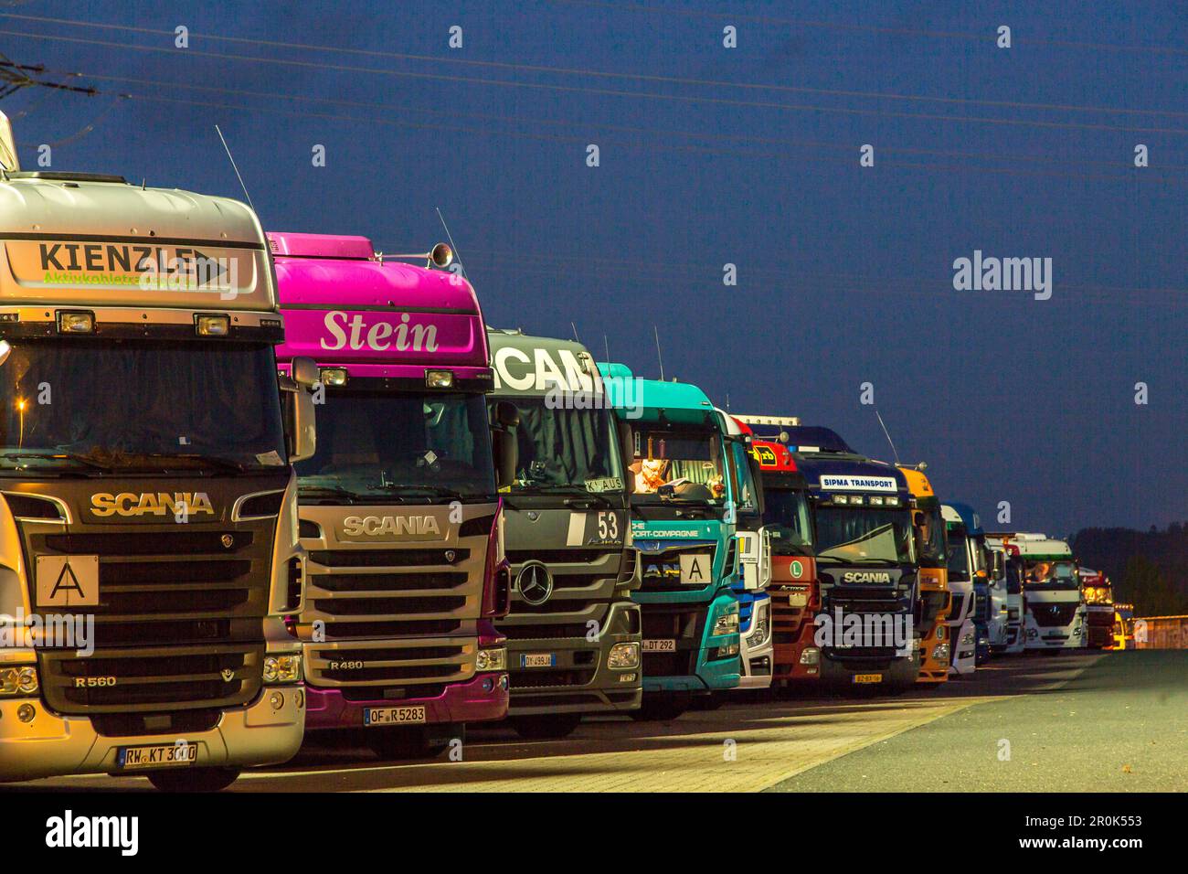 parked trucks at night, German Autobahn, A45, truck stop, motorway, highway, freeway, speed, speed limit, traffic, infrastructure, Wilnsdorf, Germany Stock Photo