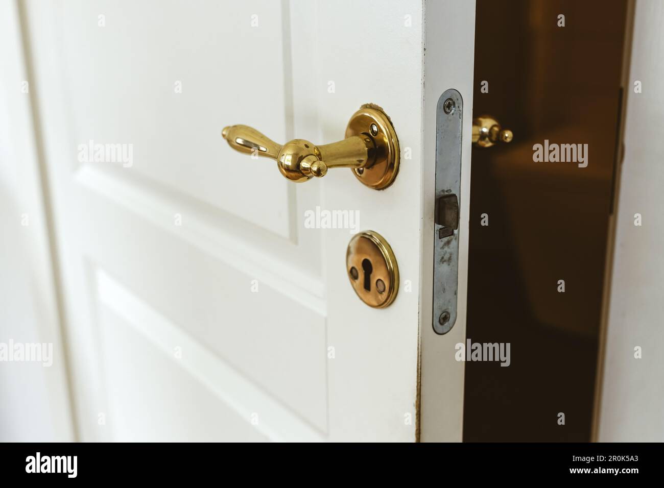 Bathroom door with vintage brass handle, selective focus Stock Photo