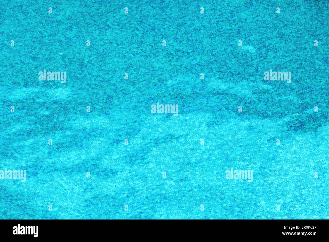 Blue ceramic tiles at the bottom of the swimming pool distorted by ...