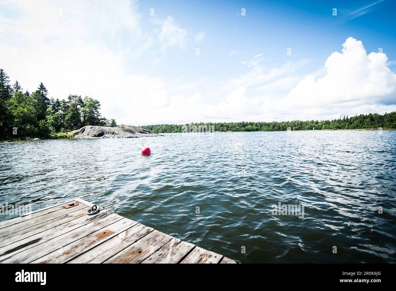 view from the landing stage to the sea, wood and rocks, Oregrund, Uppsala, Sweden Stock Photo