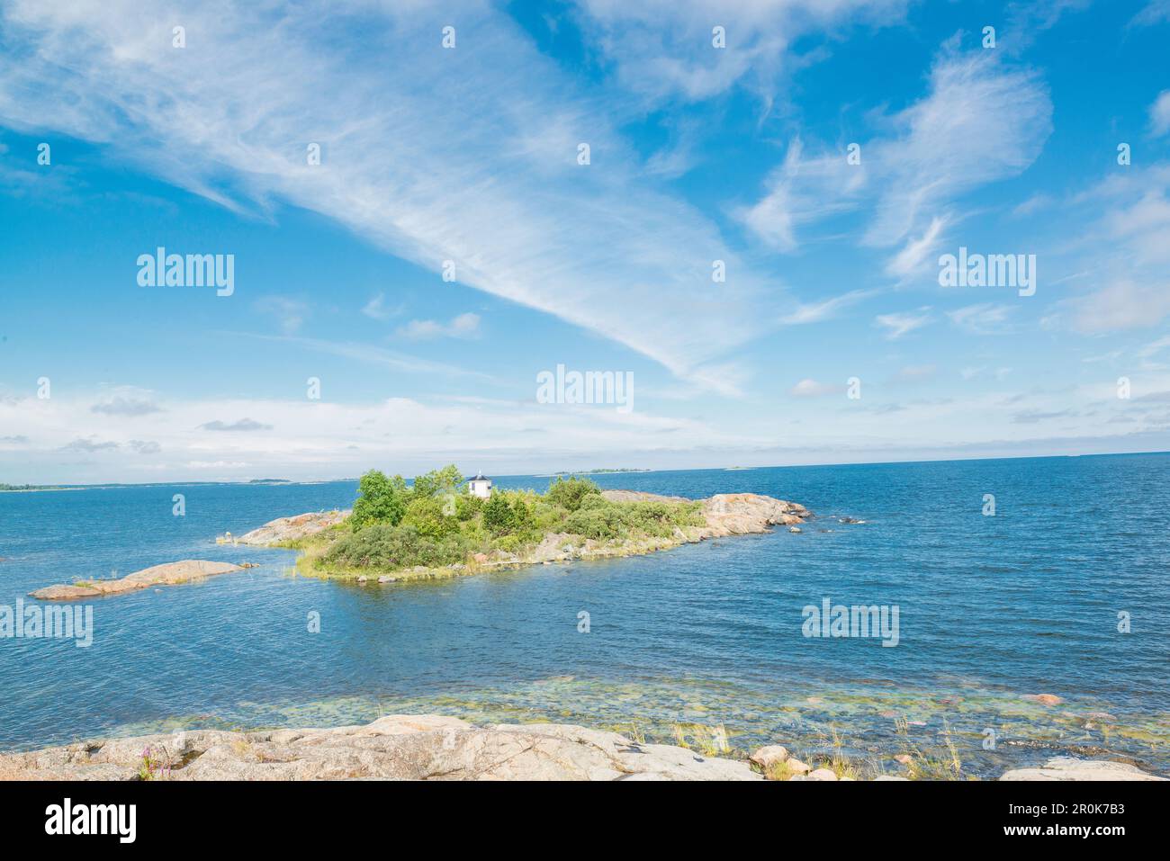 view towards a little island in the sea under a blue summer sky, Oregrund, Bothnian sea, Uppsala, Sweden Stock Photo