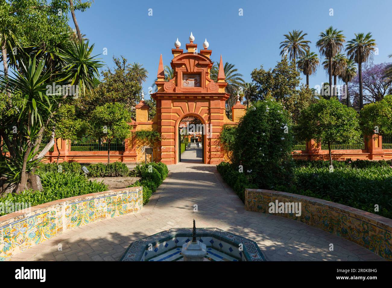 Gateway with palm trees, Jardin Marques de la Vega Inclan, Jardines del Real Alcazar, garden of the royal palace, UNESCO World Heritage, Sevilla, Anda Stock Photo