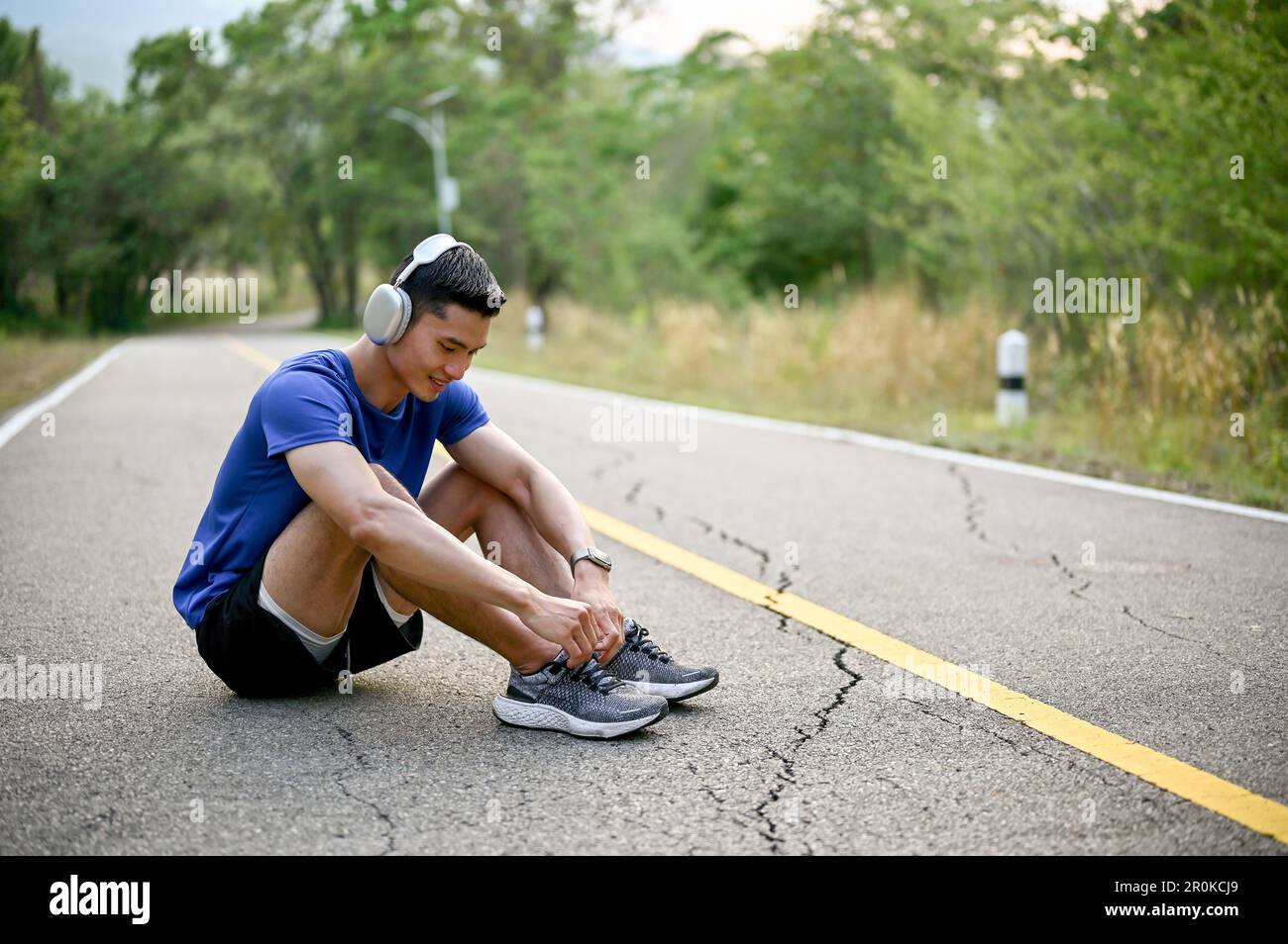 Sporty man jogging in a park stock photo