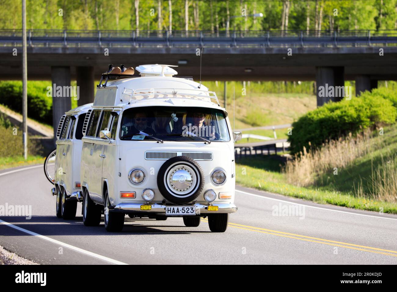 White 1972 VW camper van, or Type 2 or kleinbus with matching trailer year 2005 on road on Salon Maisema Cruising 2019. Salo, Finland. May 18, 2019. Stock Photo
