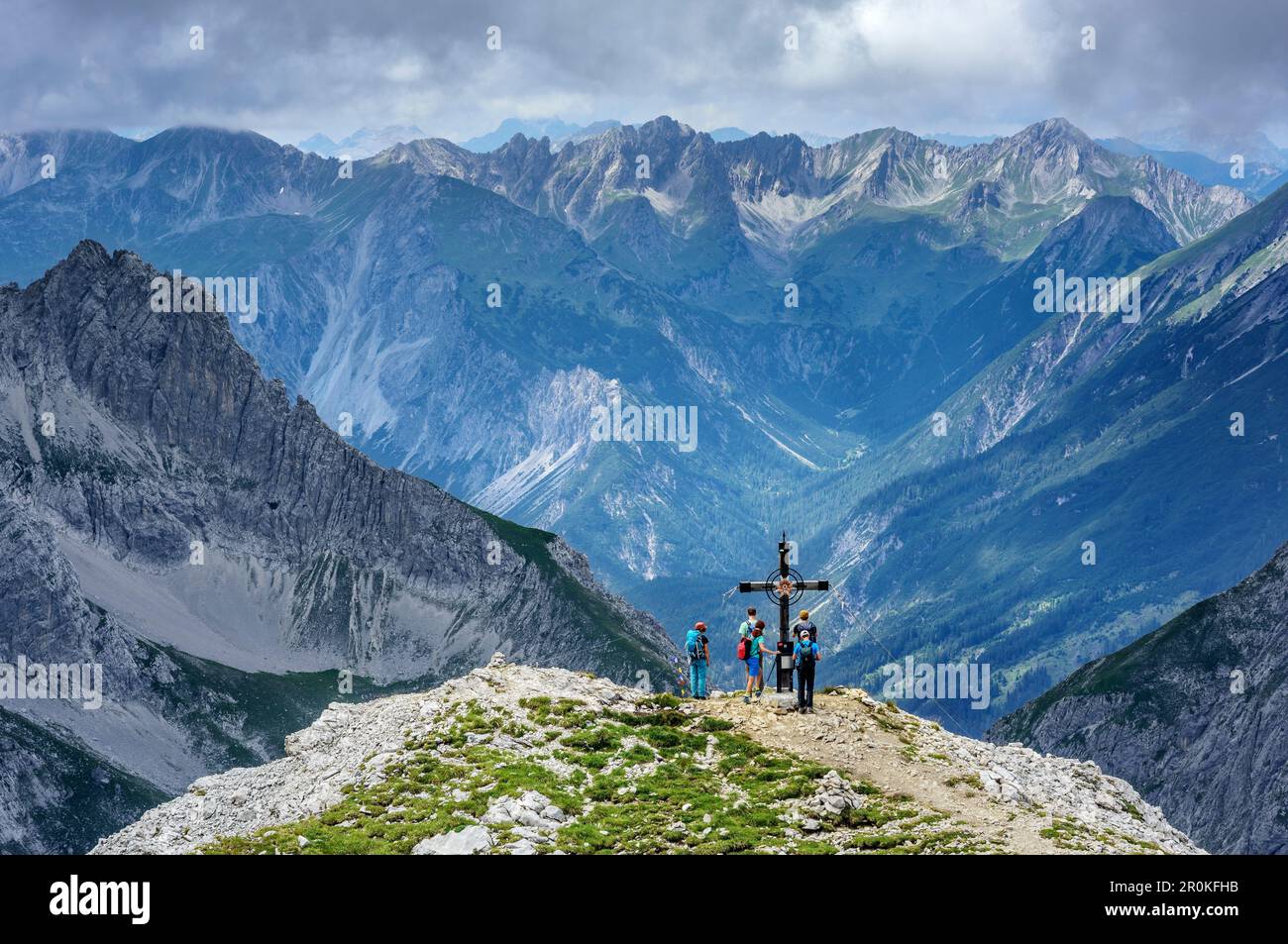 Several persons hiking standing at Hinterer Tajakopf, Hinterer Tajakopf, Mieming Mountains, Tyrol, Austria Stock Photo