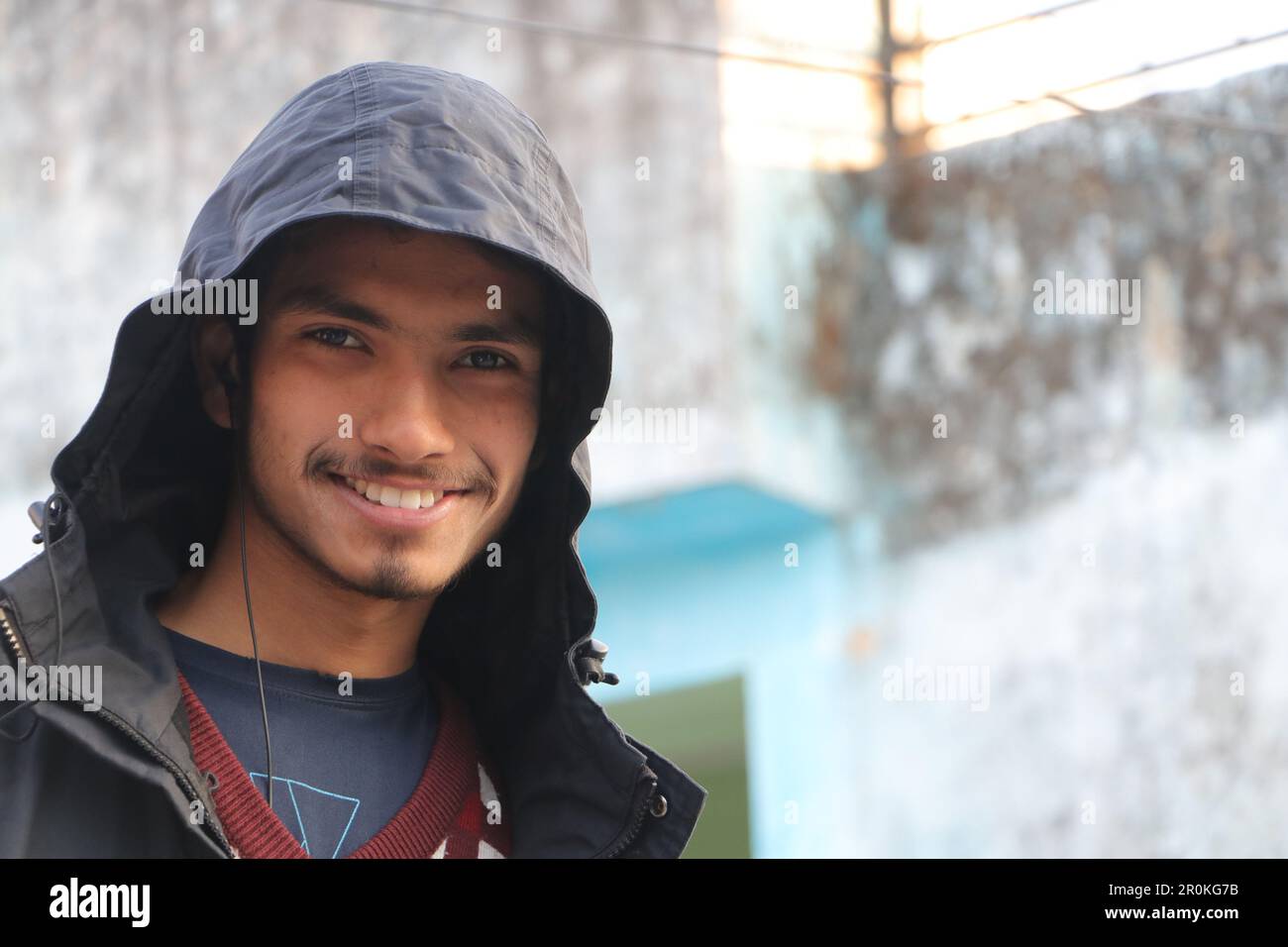 A Young Beautiful Boy Smiling in Portrait. Wearing hoodie, outside in street looking in camera. Stock Photo