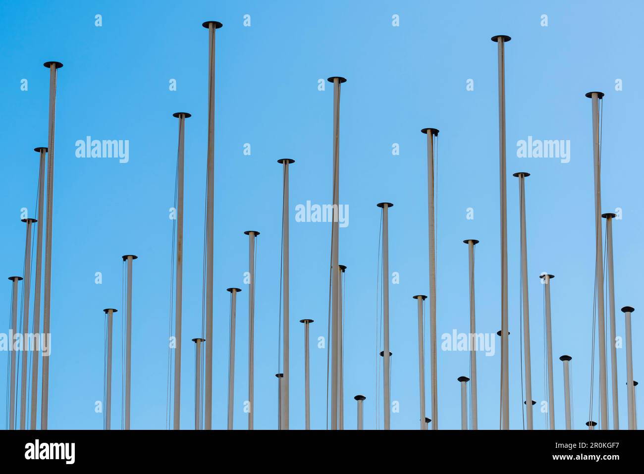 A accumulation of flagpoles in front of blue sky, Lisbon, Portugal Stock Photo