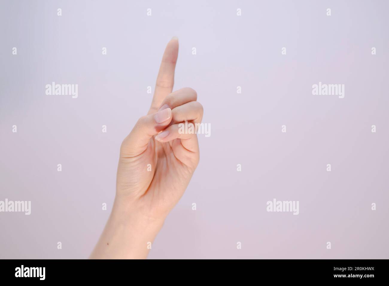 Index finger sign on white isolated background, feman pointing at something closeup of hand Stock Photo