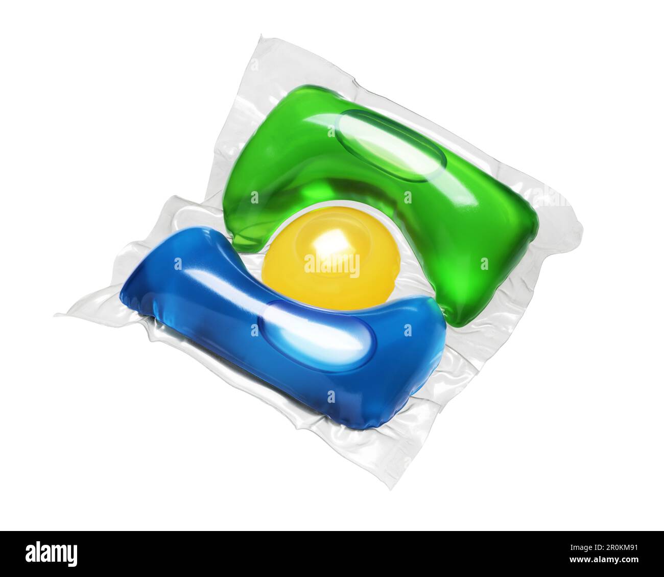 Laundry detergent pod blue, green and yellow colored isolated on white background. Stock Photo