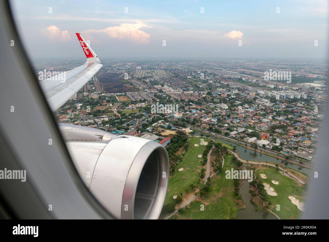 Bangkok Thailand - March 30, 2019:The image depicts the view outside the window showing the wing and engine of an AirAsia low-cost airline aircraft du Stock Photo