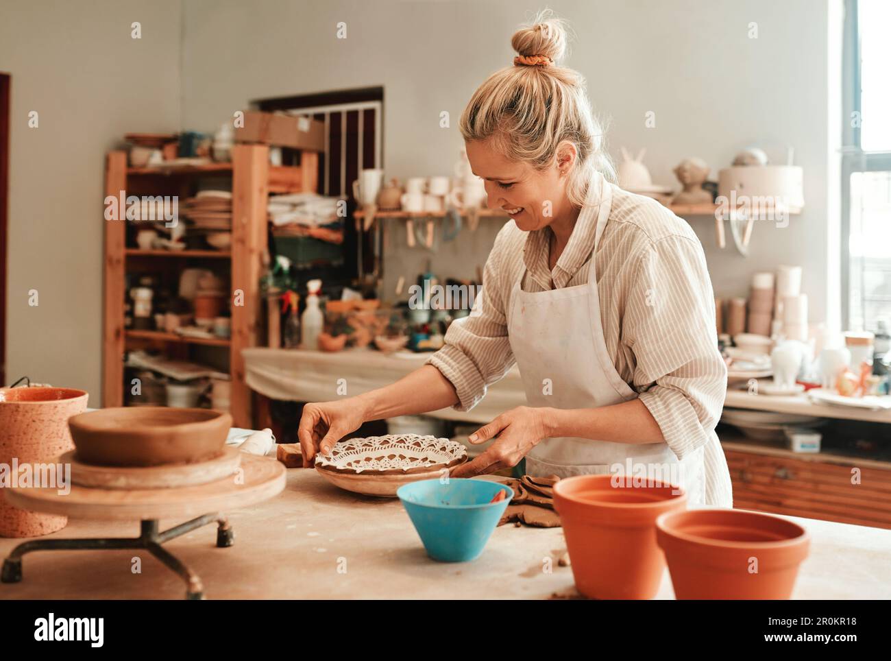 Do more of what you love. a female artisan working in her pottery ...
