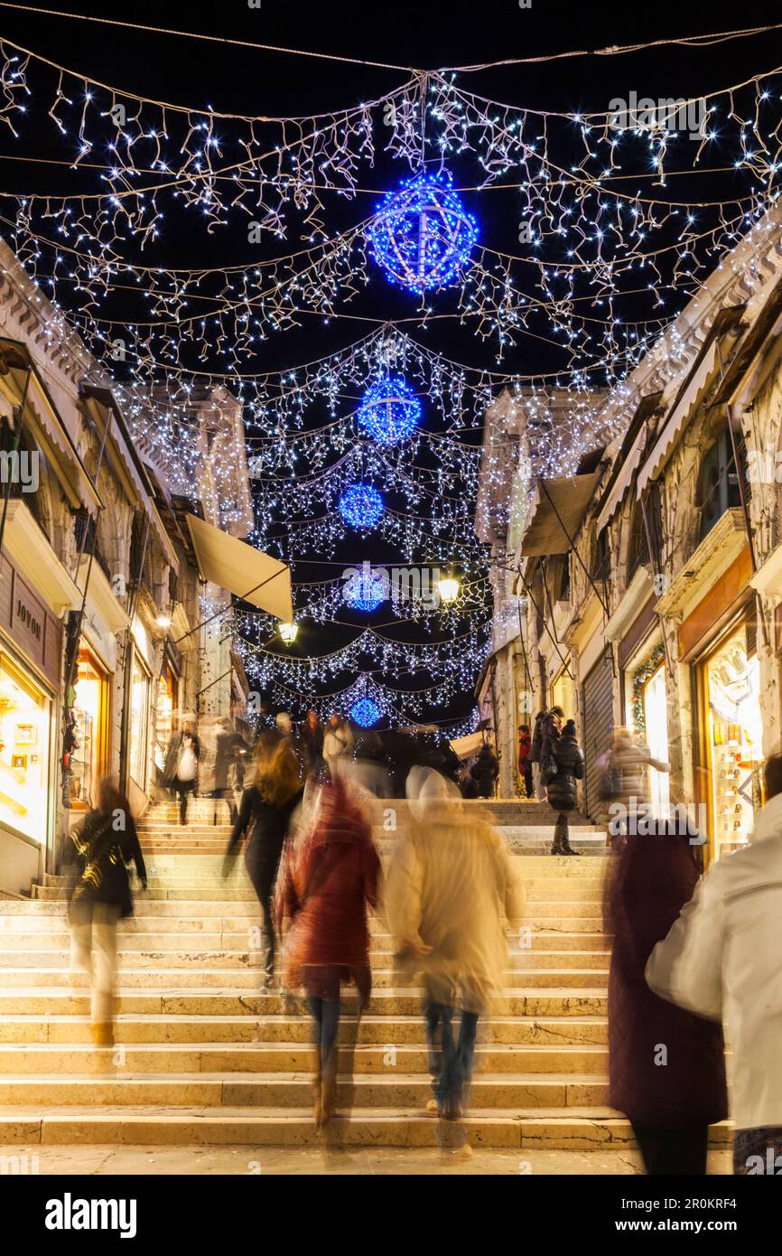 ITALY, Venice. Christmas decorations hangs over the steps leading up to