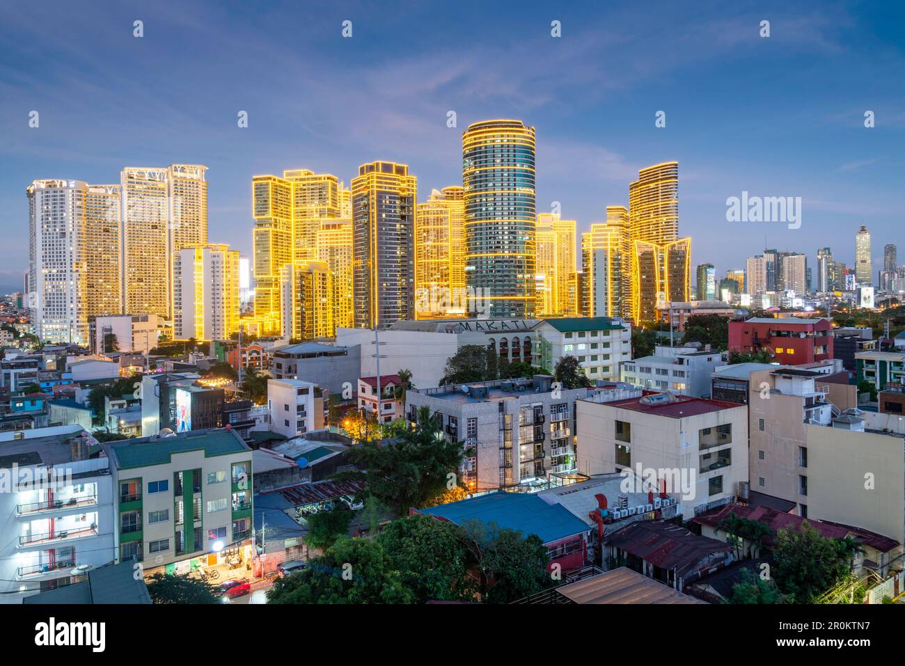 After sundown,the modern high rise apartment and office blocks of Makaiti come to life,when the beautiful bright golden flourescent strip lights cover Stock Photo