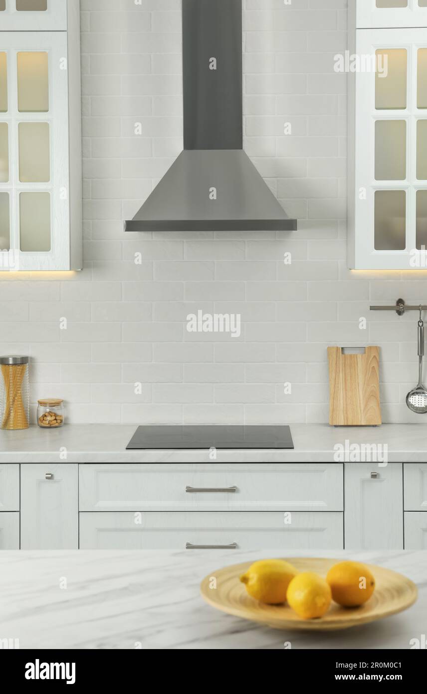 Elegant kitchen interior with modern range hood over cooktop and