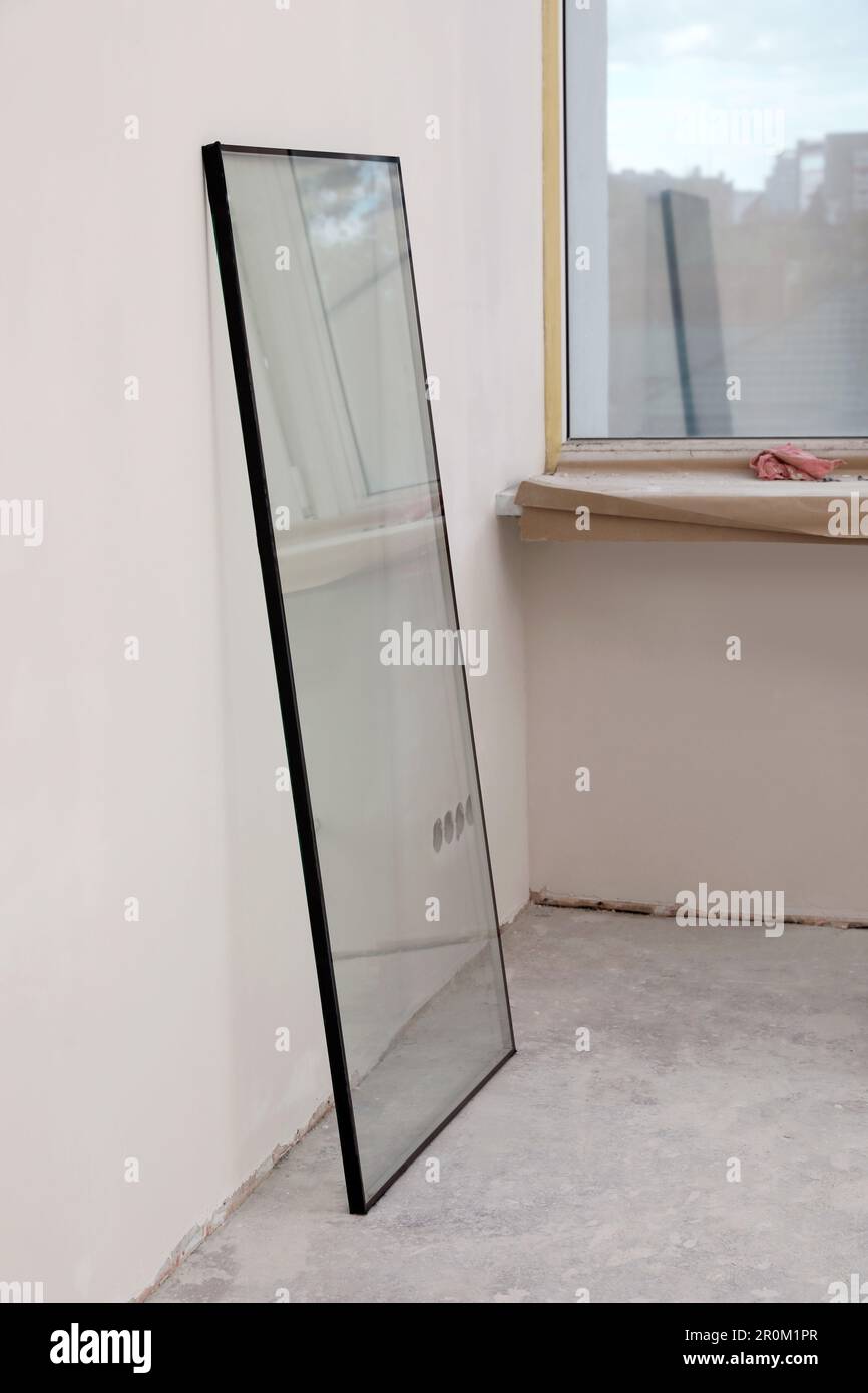 Double glazing window on floor near plasterboard wall indoors Stock Photo