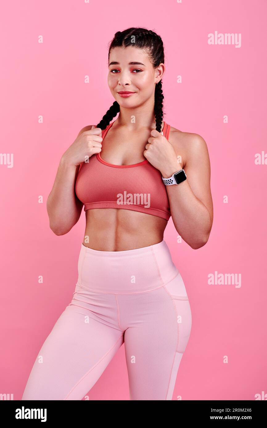 Ive overcome so many things that I thought were impossible. Studio portrait of a sporty young woman posing against a pink background. Stock Photo