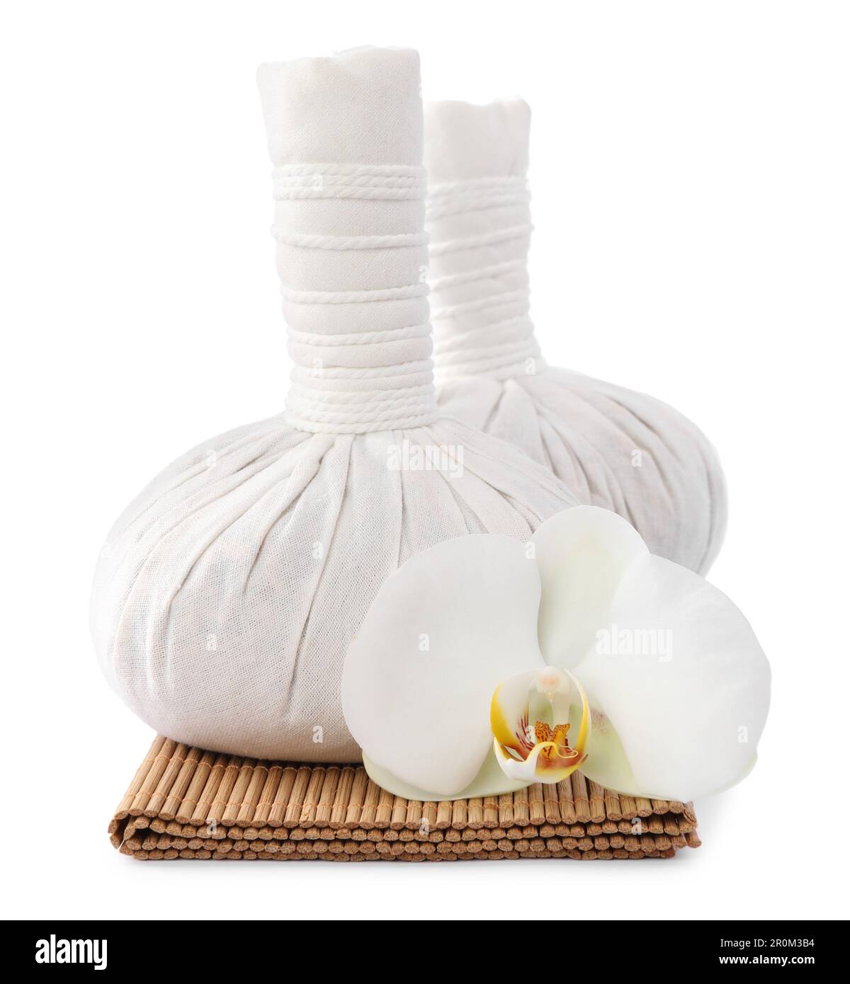 Herbal massage bags and flower on white background. Spa supply Stock