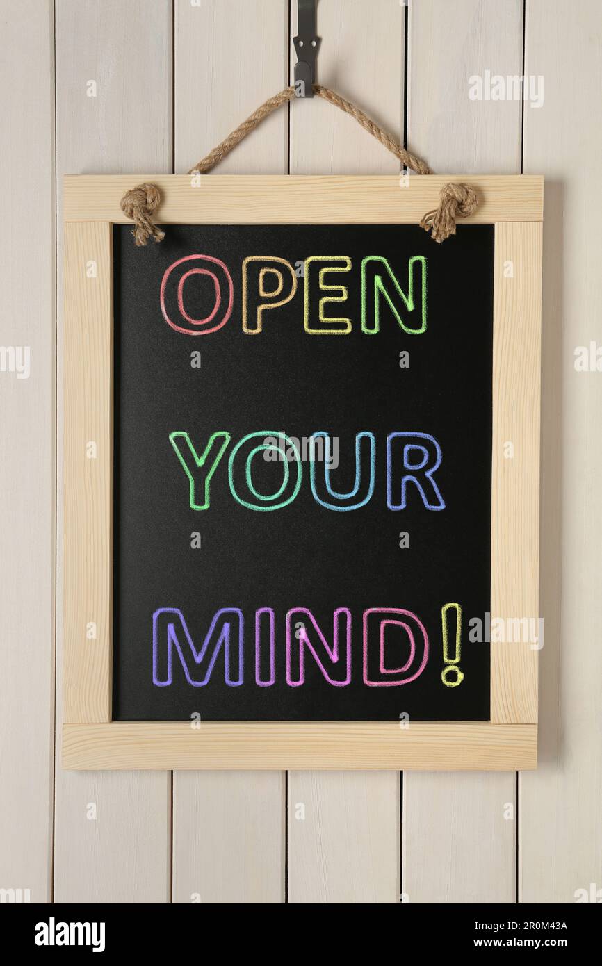 Small chalkboard with motivational quote Open your mind hanging on