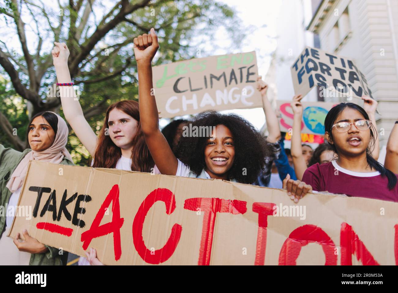 Happy youth activists marching against climate change and global