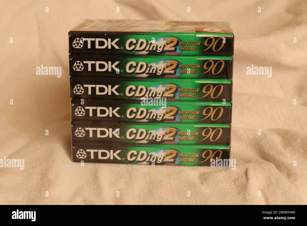 A pack of 6, TDK manufactured, cassette tapes. The tape format is