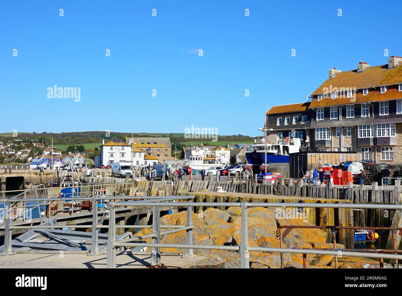 View of the harbour area with town buildings to the rear, West Bay, Dorset, UK, Europe. Stock Photo