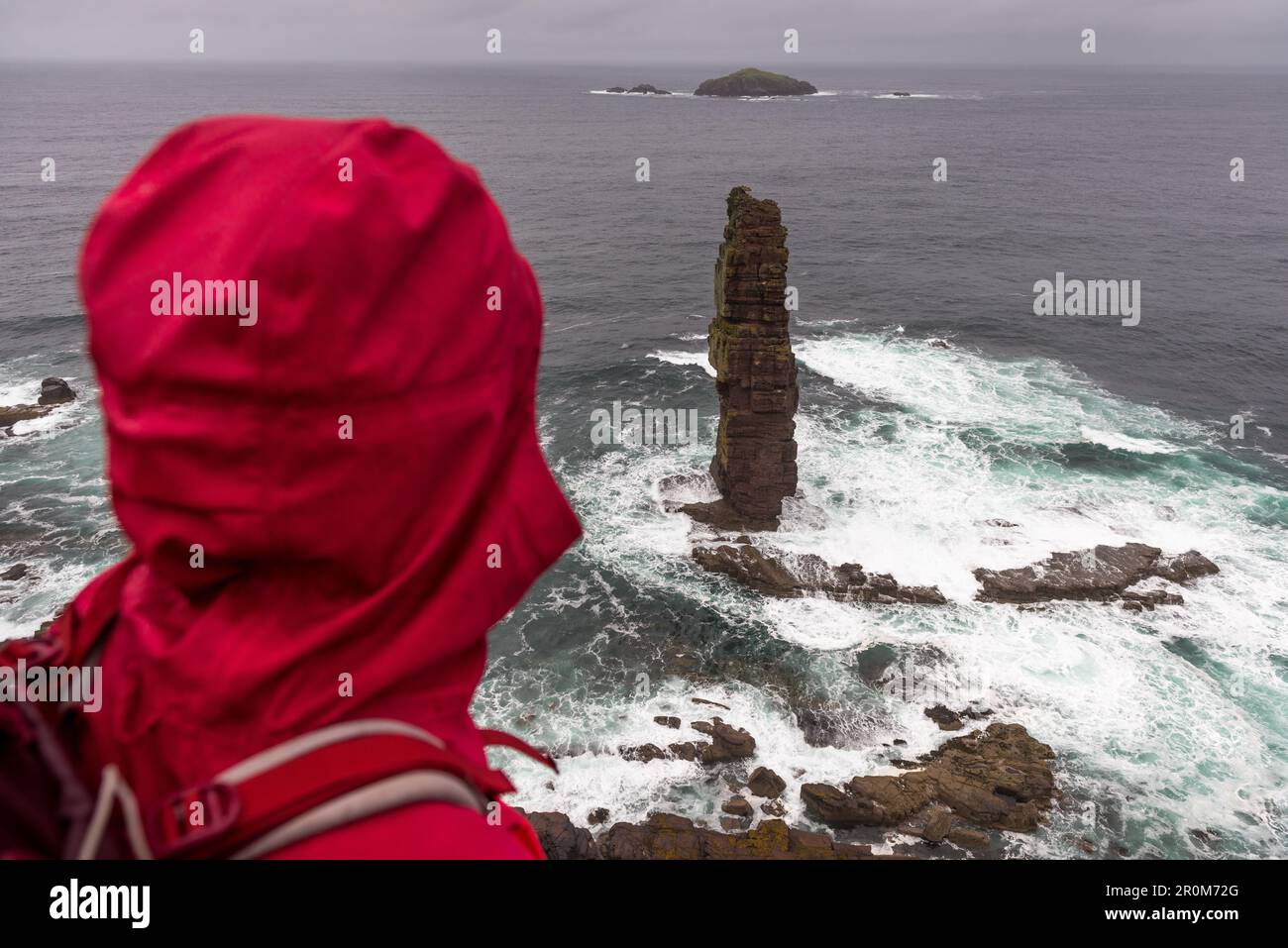 A female wanderer looks out over the Am Buachaille, Sandwood Bay, Highlands, Scotland, UK Stock Photo