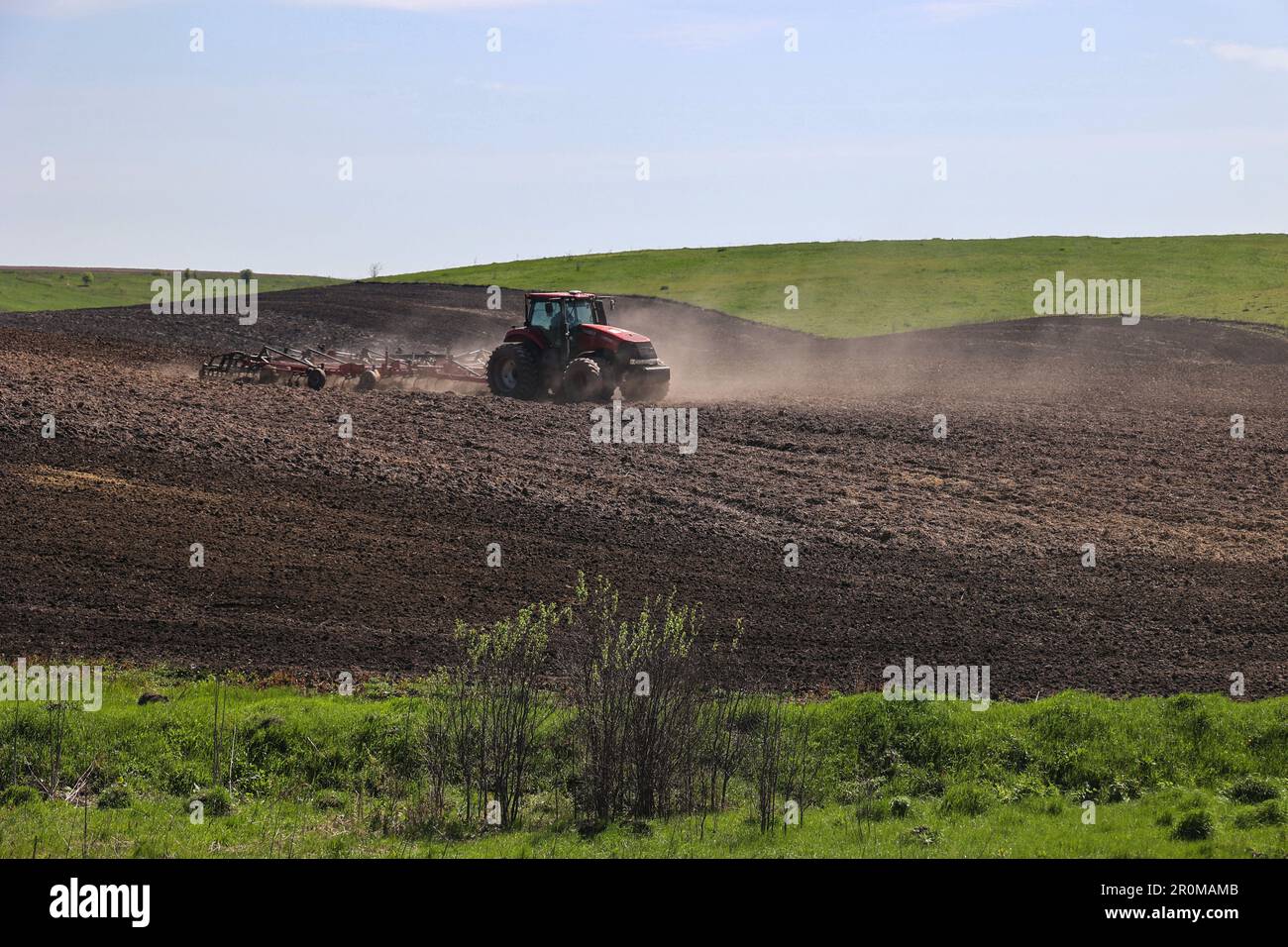 KHARKIV REGION, UKRAINE - MAY 7, 2023 - A tractor is seen in the field ...