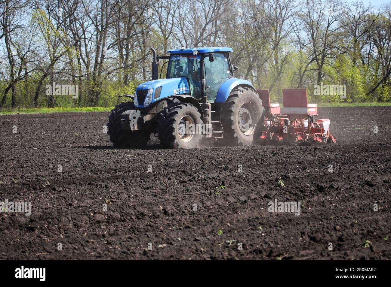 KHARKIV REGION, UKRAINE - MAY 7, 2023 - A tractor is seen in the field ...