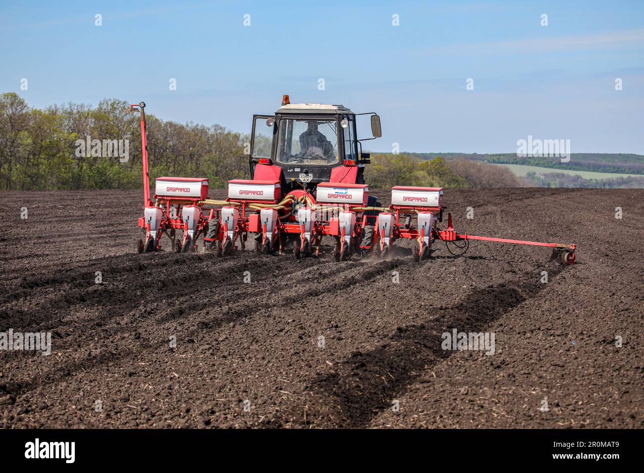 KHARKIV REGION, UKRAINE - MAY 7, 2023 - A tractor is seen in the field ...