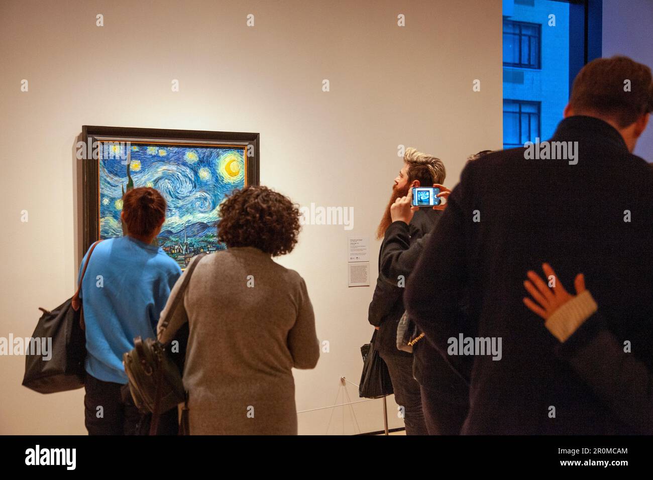 Visitors Stand Around Van Gogh's Painting 'The Starry Night' at MOMA in New Yor, USA Stock Photo