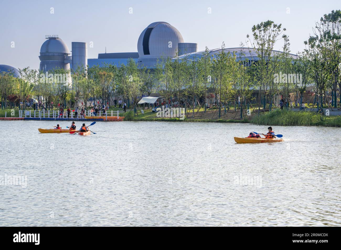 Kayakers on the Chunlian River in front of the Shanghai Astronomy Museum in Lingang, Pudong New Area, Shanghai, China. Stock Photo