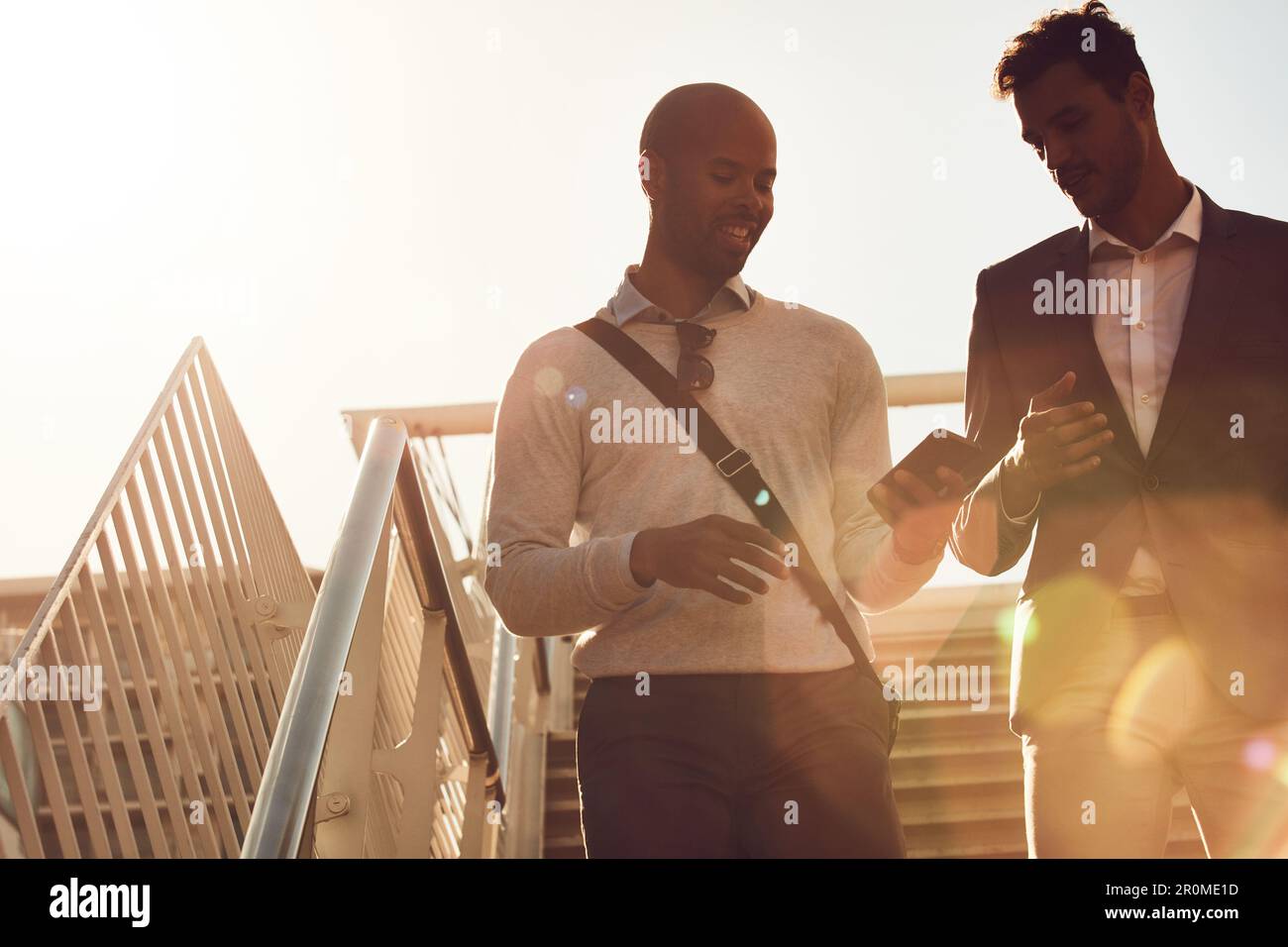 Businessmen walking down stairs hi-res stock photography and images - Alamy