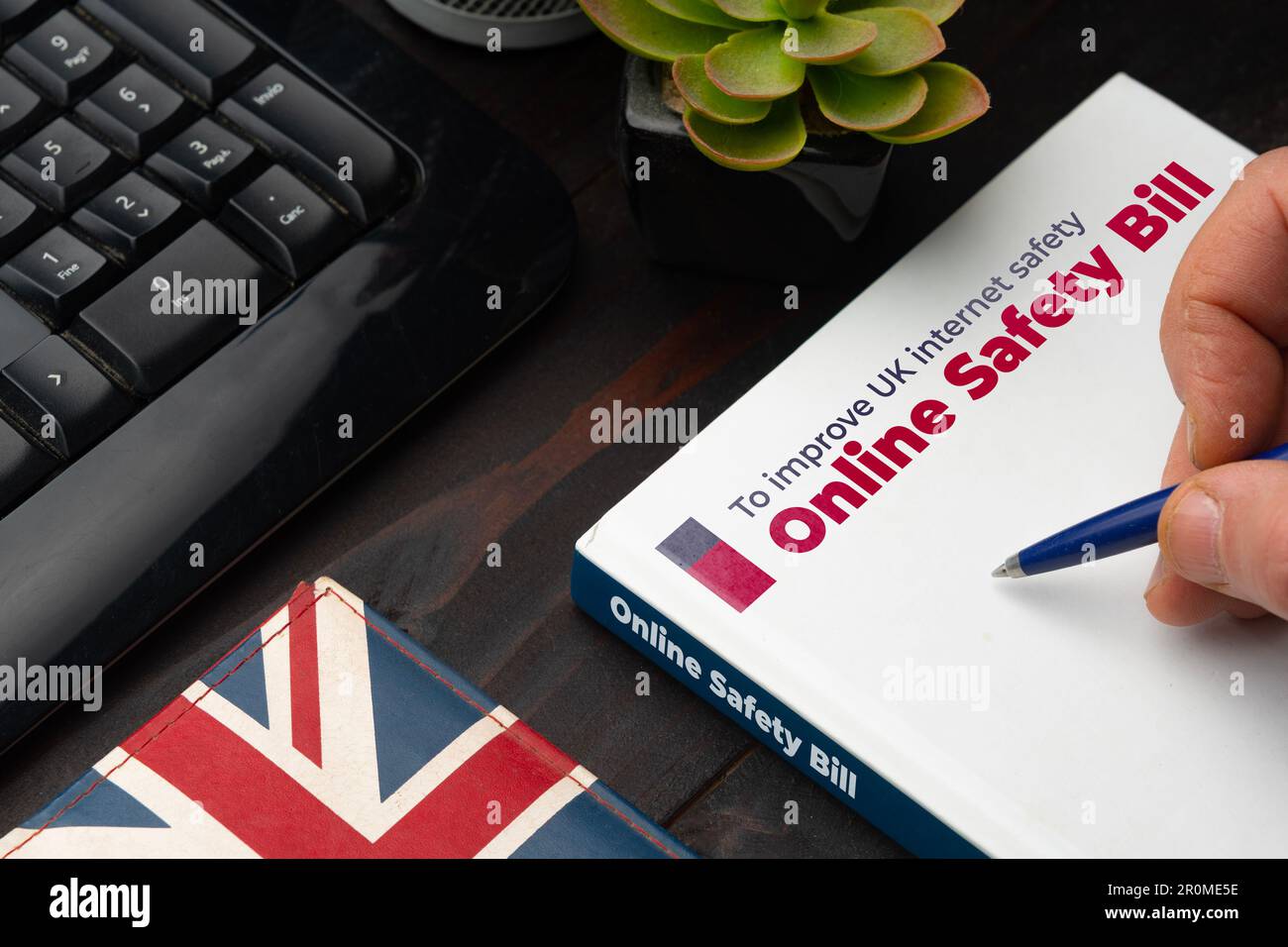 Online Safety Bill UK concept: man about to sign the new safety bill for the United Kingdom Stock Photo