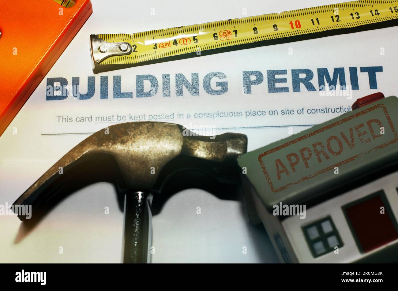 Building Permit concept with “approved” text on a residential home