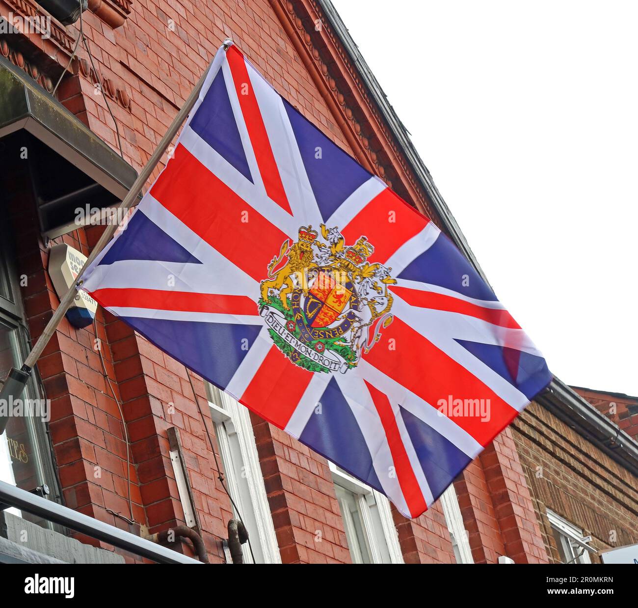 King Charles coronation union jack flag, flying above A Ward butchers, 35 London Road, Stockton Heath, Warrington, Cheshire, England, UK, WA4 6SG Stock Photo