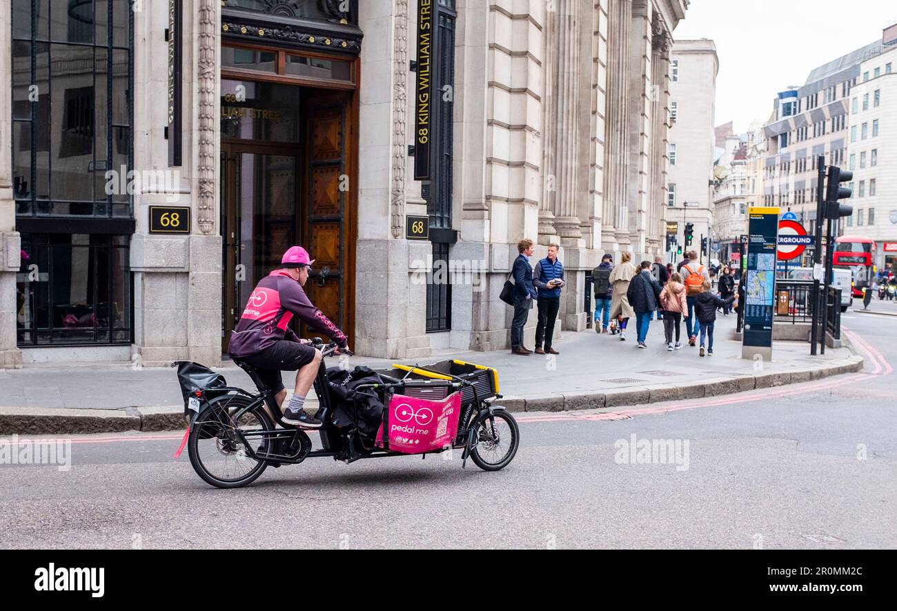 London Views  - Cycling delivery rider in city of London , UK Stock Photo