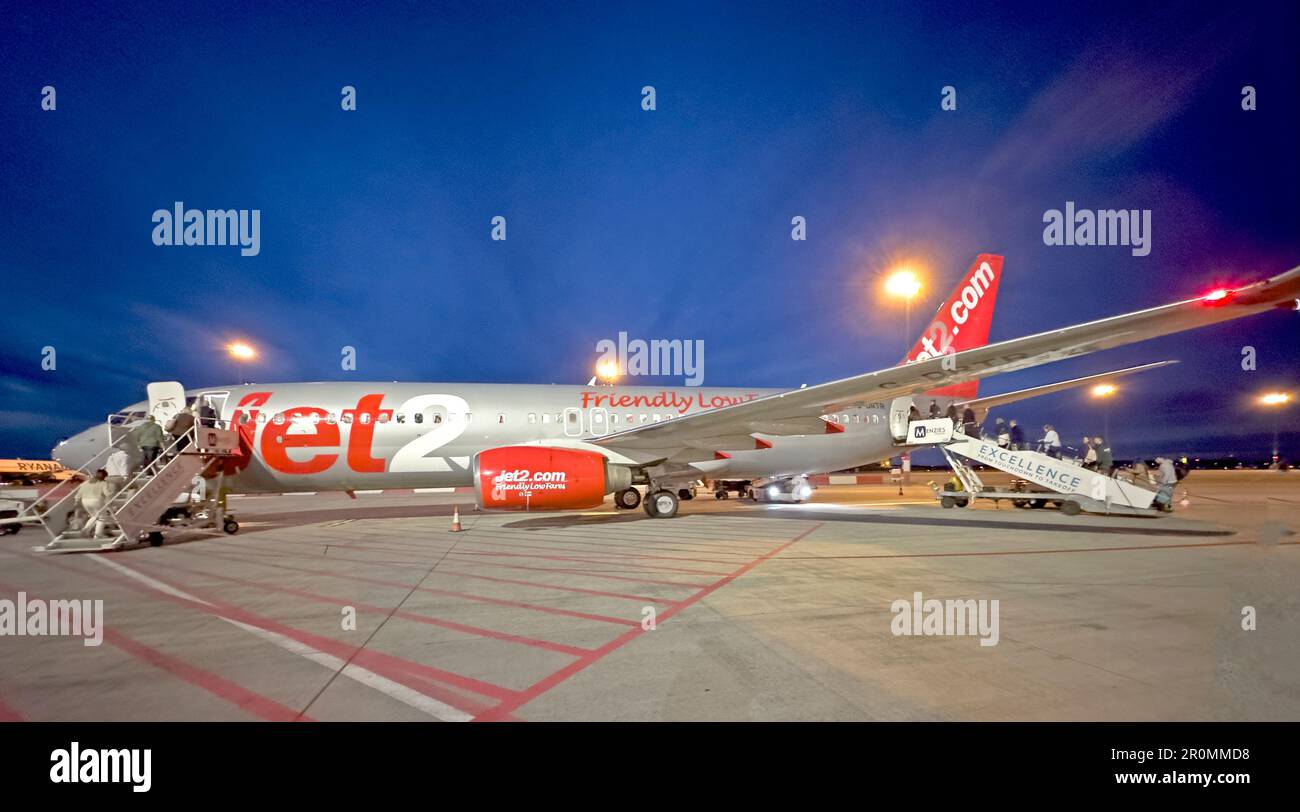Panorama shot, Jet2 Aircraft G-DRTR being boarded at dusk, Boeing 737-300 Stock Photo