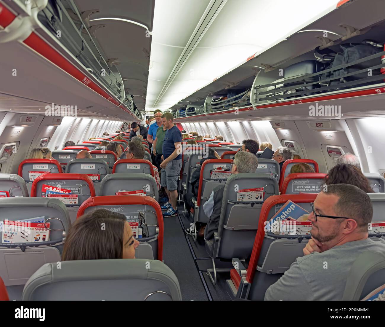 Jet2 airline cabin, prior to take-off, showing walk-on baggage in overhead lockers, Boeing G-JZHN 737-8MG Stock Photo