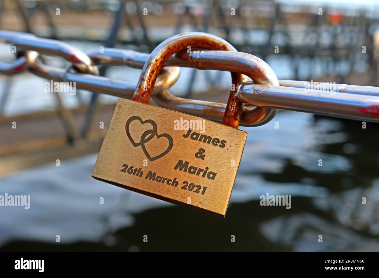 Lovelock of two hearts connected, left by James & Maria, 26th Mar 2021, in Cardiff Bay, Cymru, Wales, UK, CF99 1SN Stock Photo