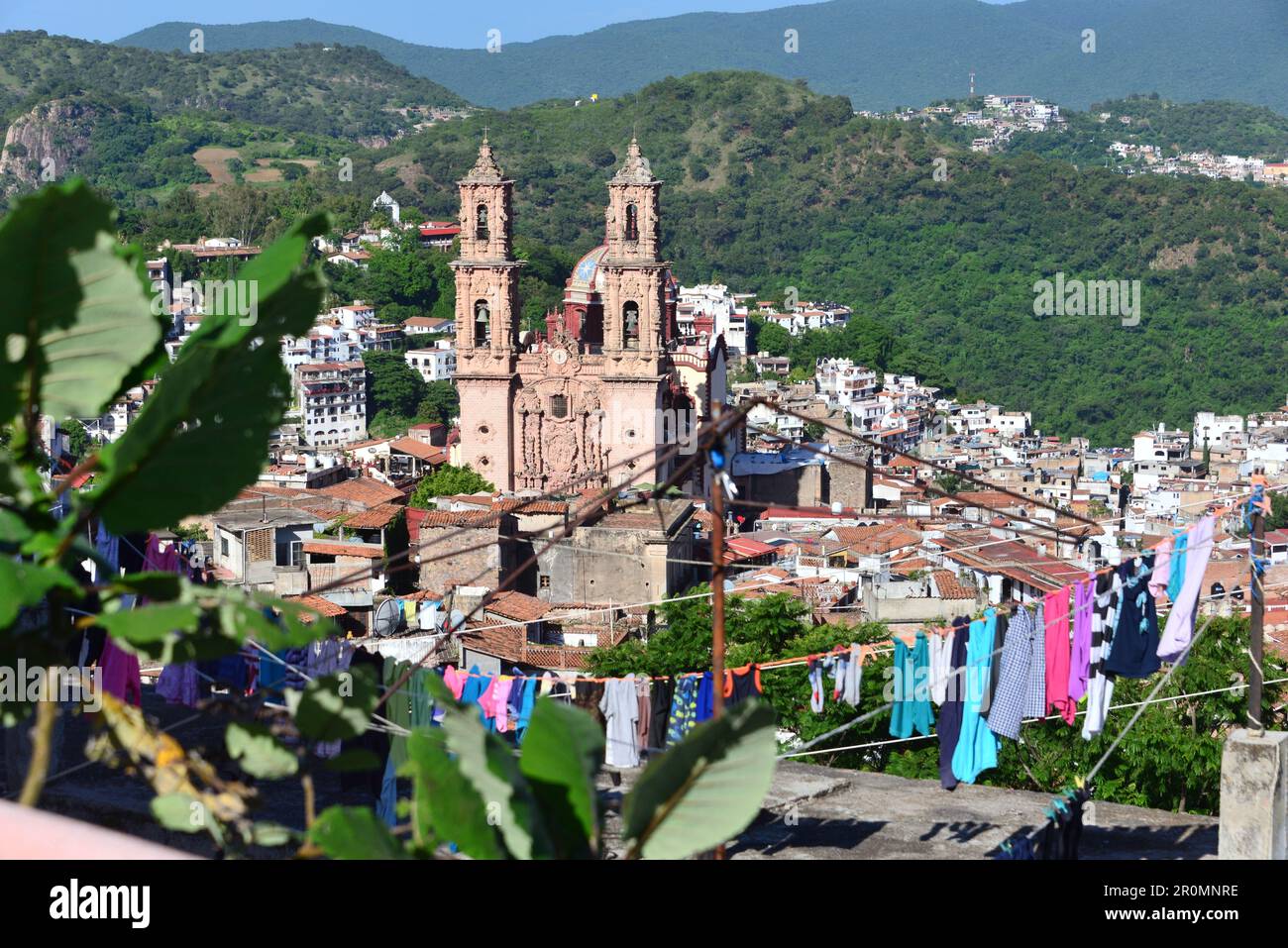 View over colorful laundry from the top of the old town and the İglisis de Santa Prisca of Taxco, Mexico Stock Photo