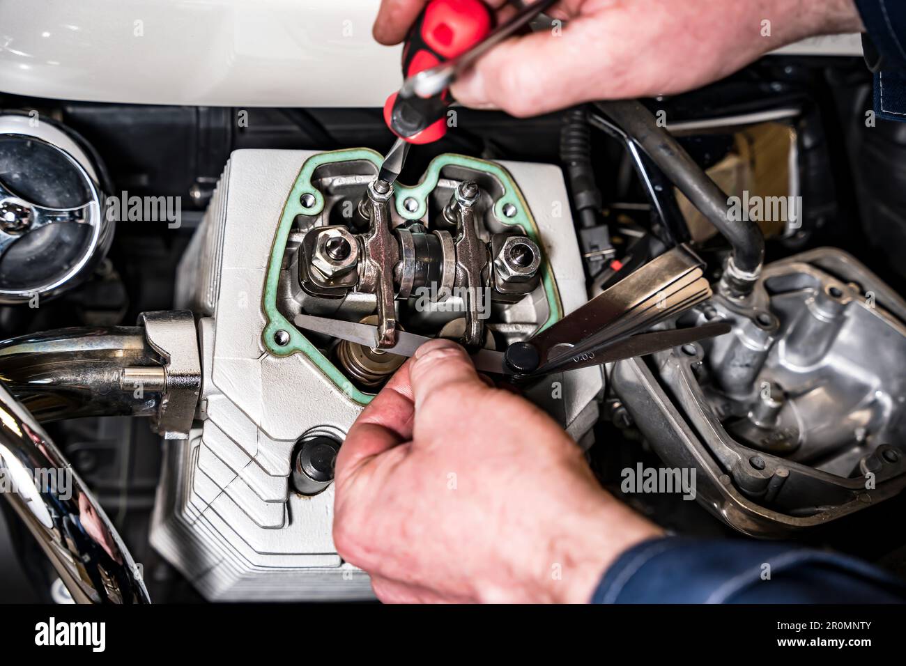 adjusting engine valves of motorcycle at the Stock Photo Alamy