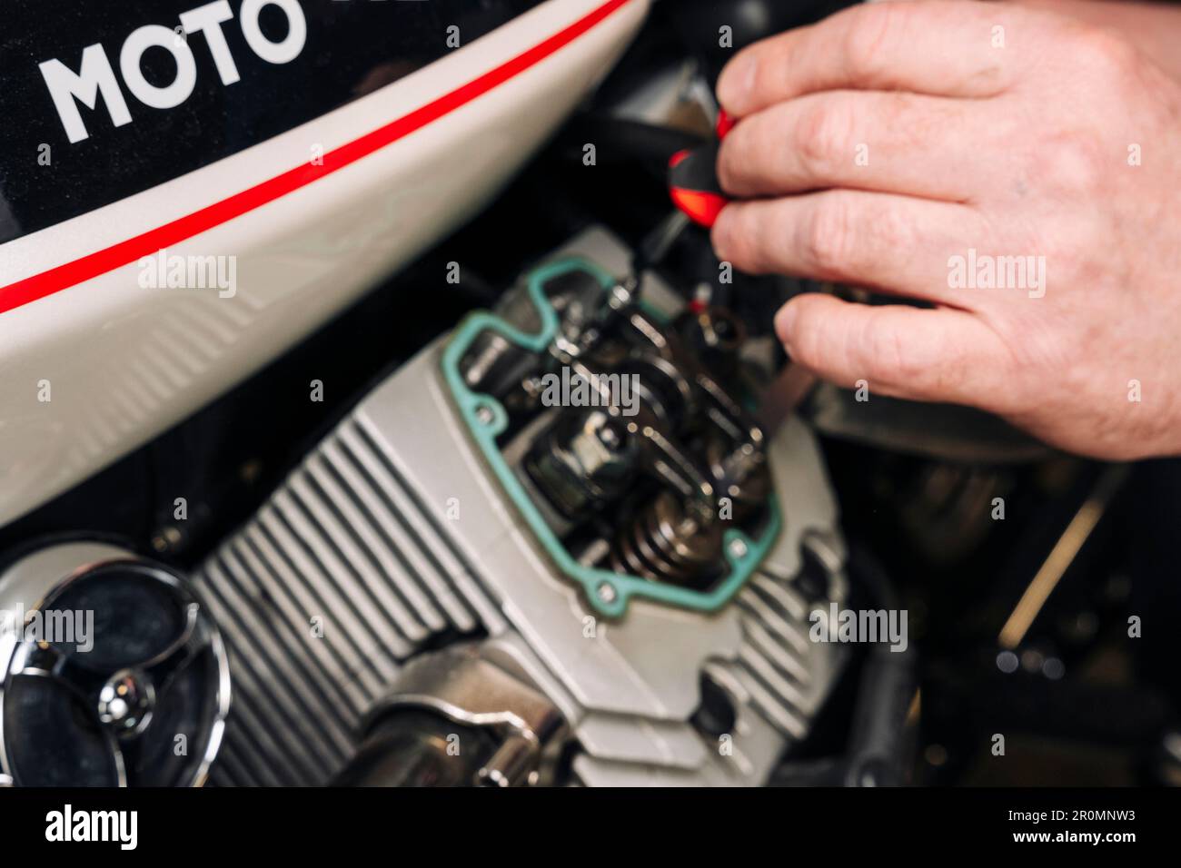 adjusting engine valves of motorcycle at the Stock Photo Alamy