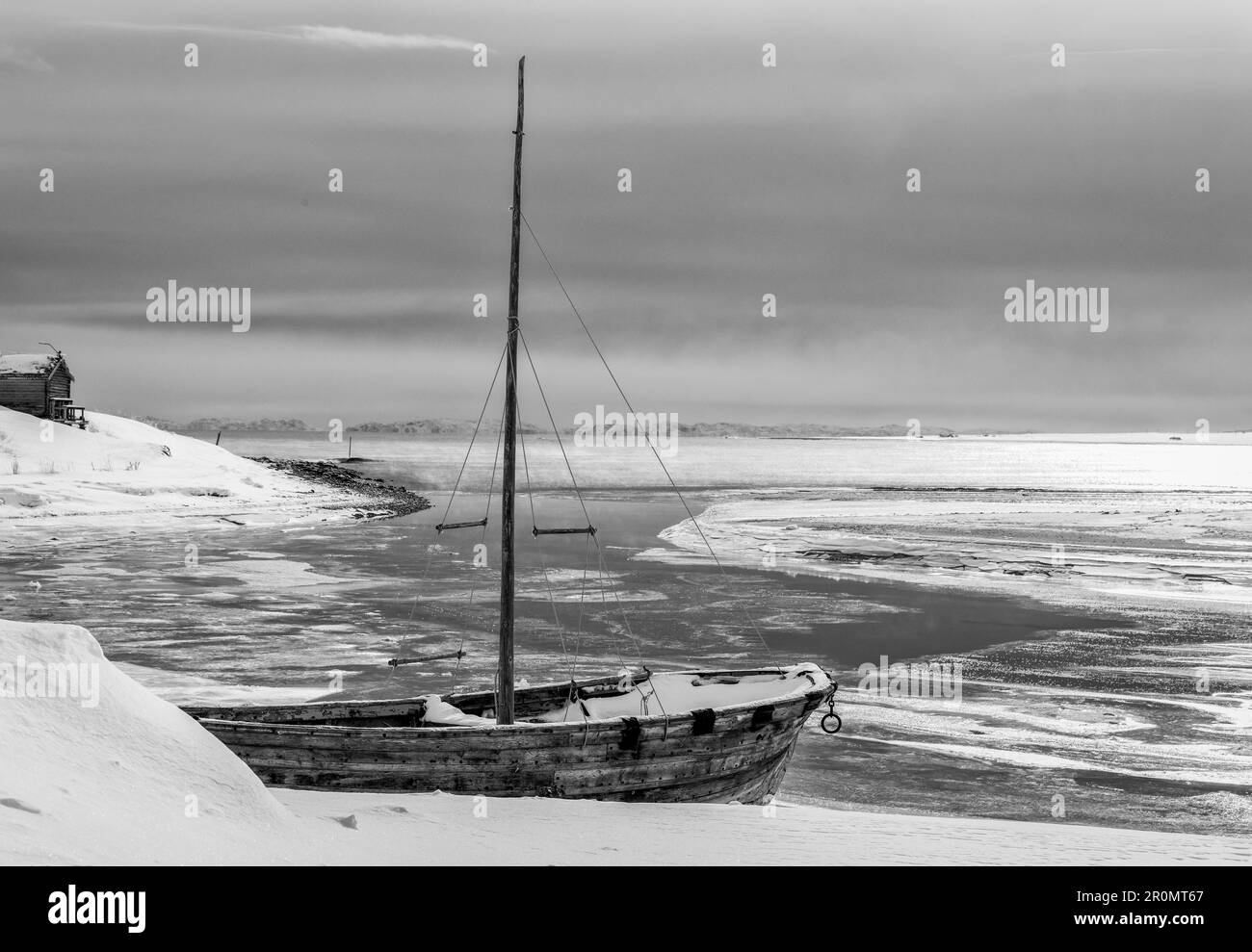 An old boat on a frozen coastline Stock Photo