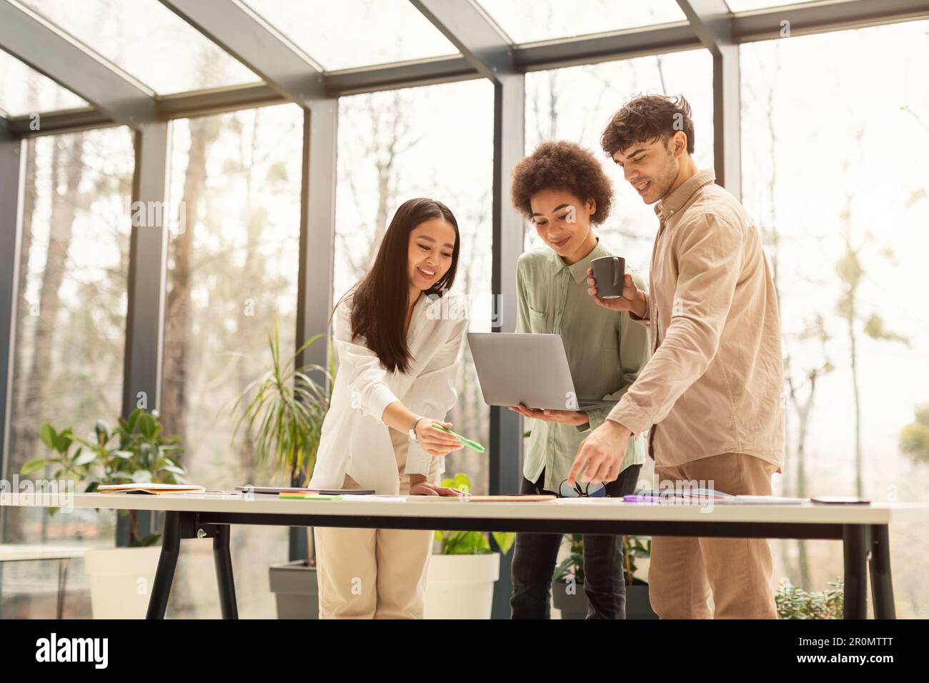 Diverse Colleagues Team Doing Productive Teamwork Using Laptop In Office Stock Photo