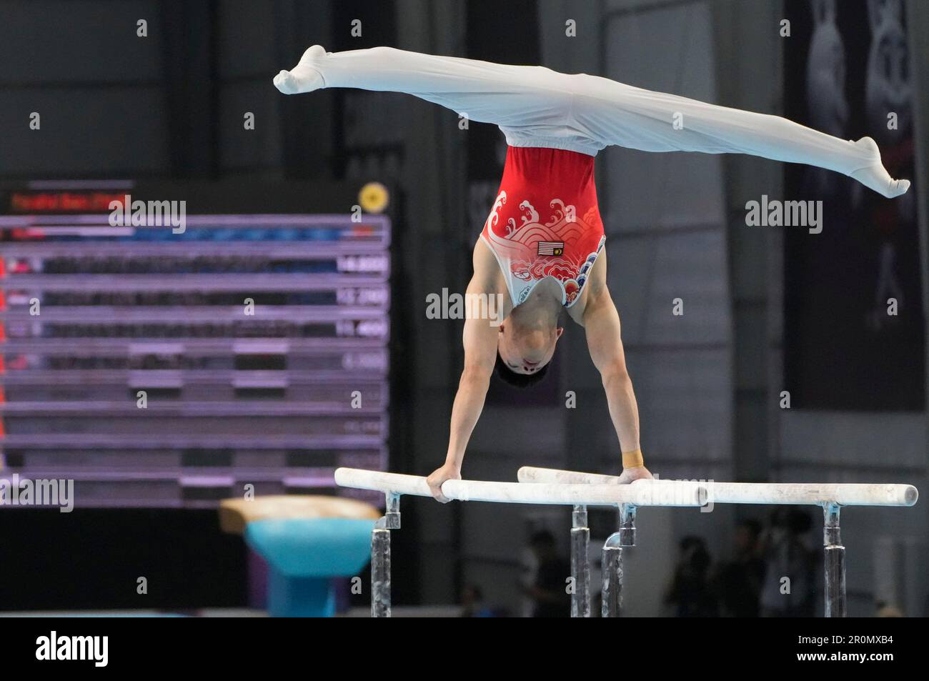 Ng Chun Chen of Malaysia performs in the men's parallel bars final ...