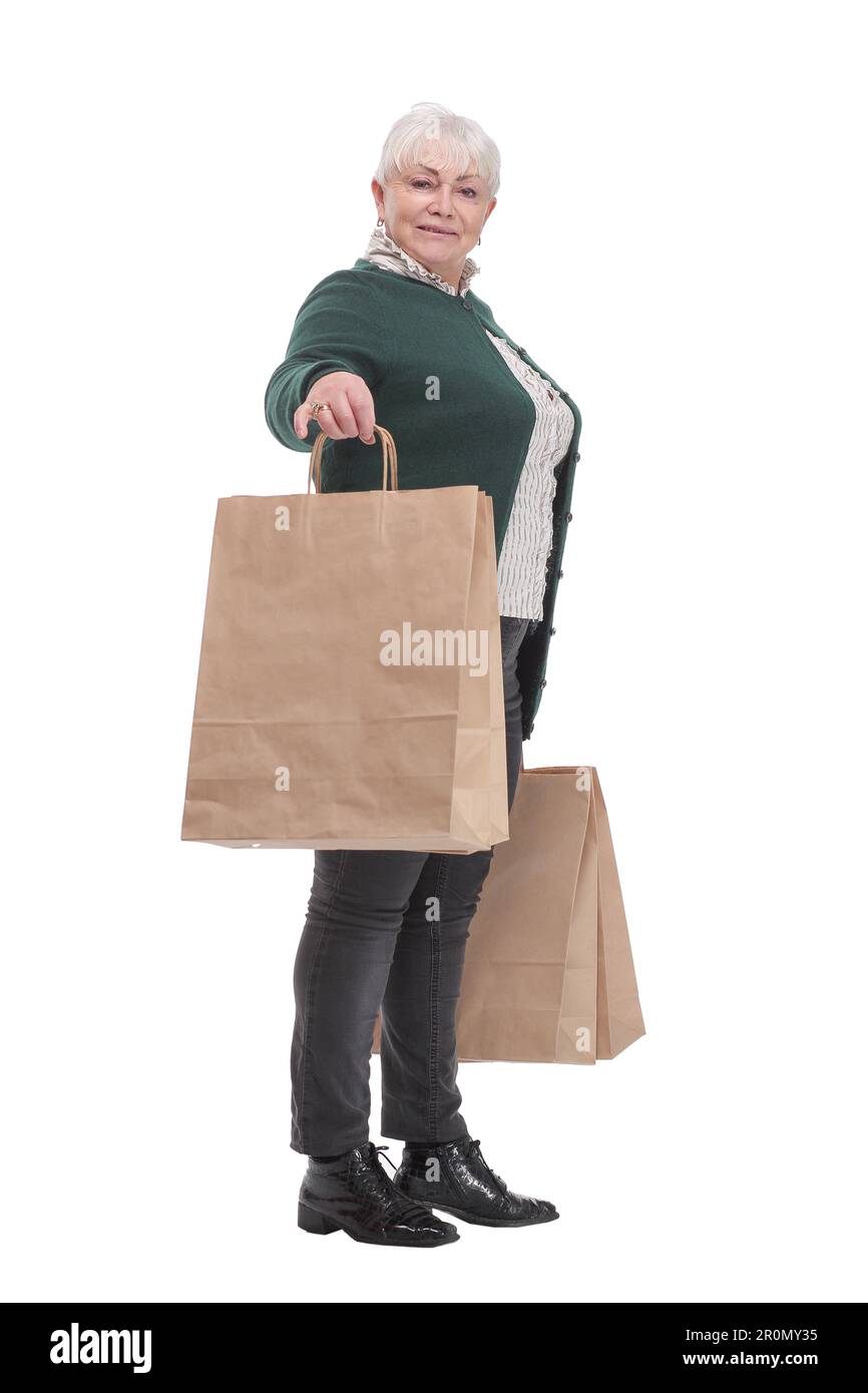 Smiling senior woman with shopping bags over white background Stock Photo