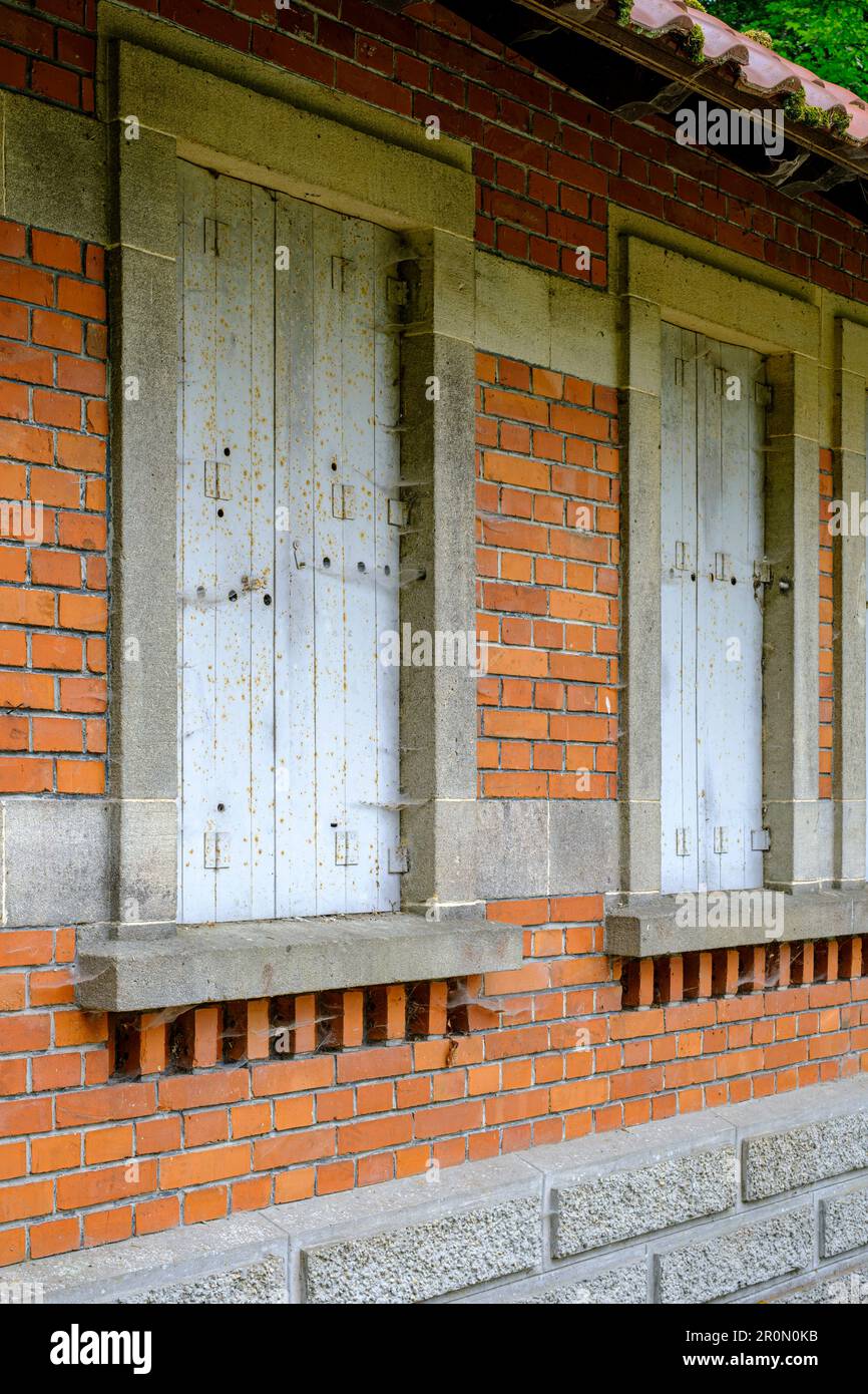 Window closed with shutters in an old brick building, Old Pump House in Honau, Swabian Alb, Germany. Stock Photo