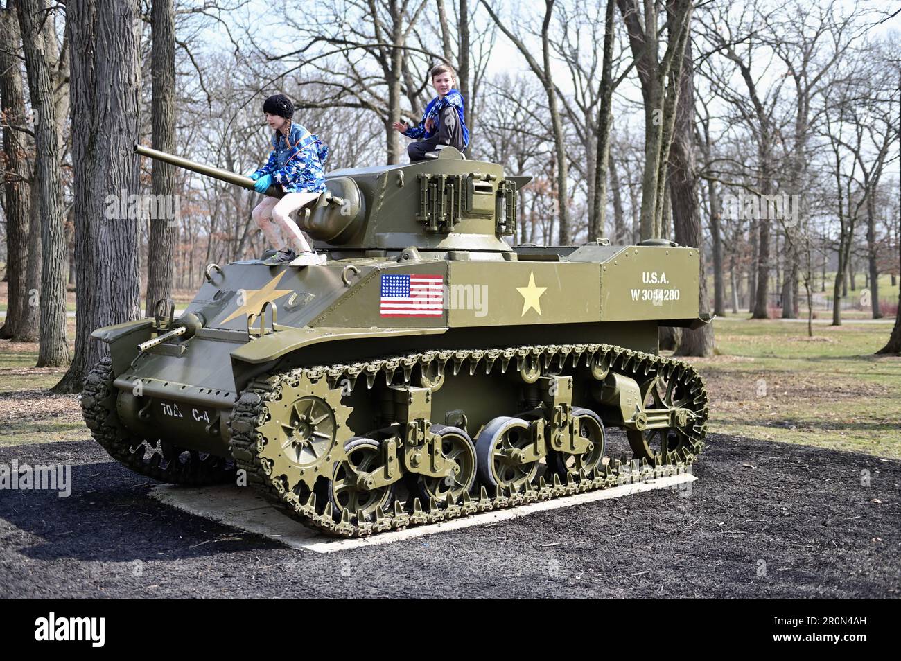 Wheaton, Illinois, USA. Children climbing on military tanks at Cantigny Park. Stock Photo